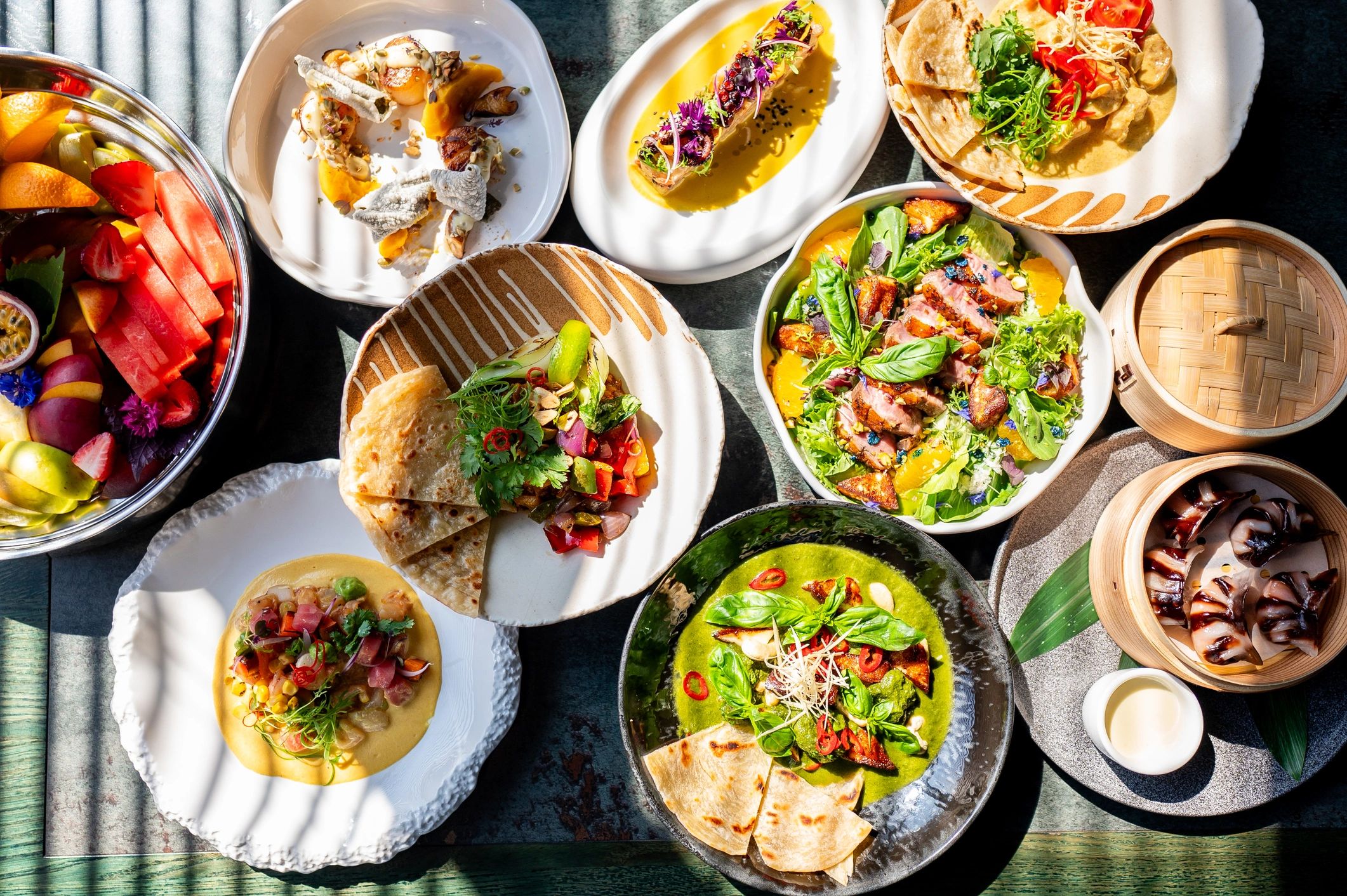 Assorted plated dishes arranged on a restaurant table