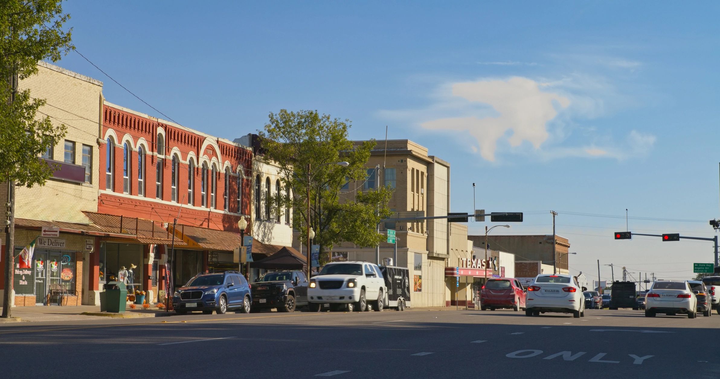Small-town Texas storefronts along a sunny main street